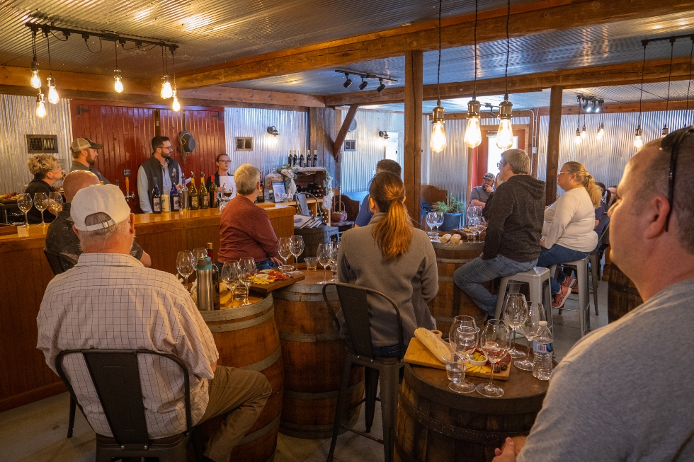 wine club guests around tables enjoying wine and food