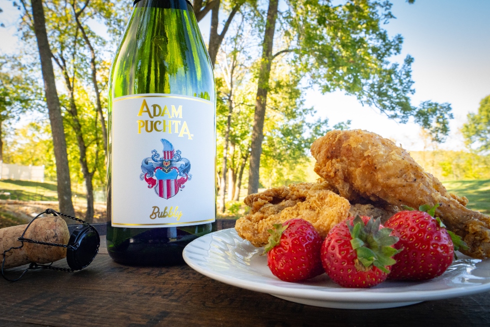 Adam Puchta Bubbly with a plate of fried chicken and strawberries